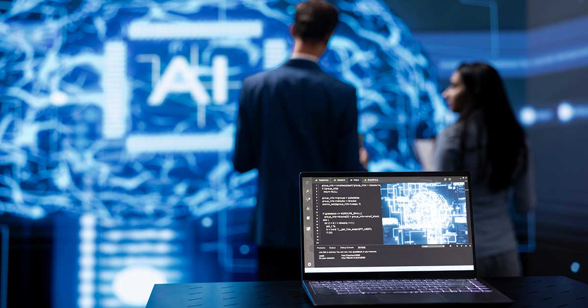 A laptop displays AI code while in the background, a man and a woman discuss AI-powered crisis simulations near a large digital brain graphic on a screen.