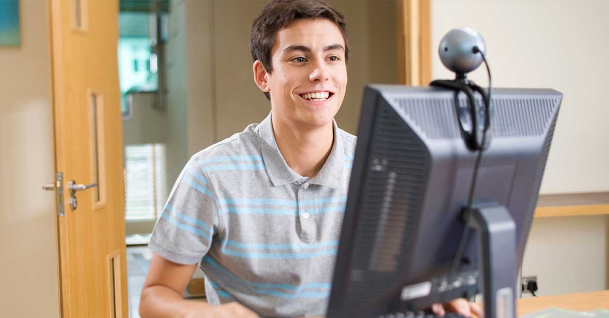 Student using speech-to-text technology instead of traditional cursive handwriting in modern classroom