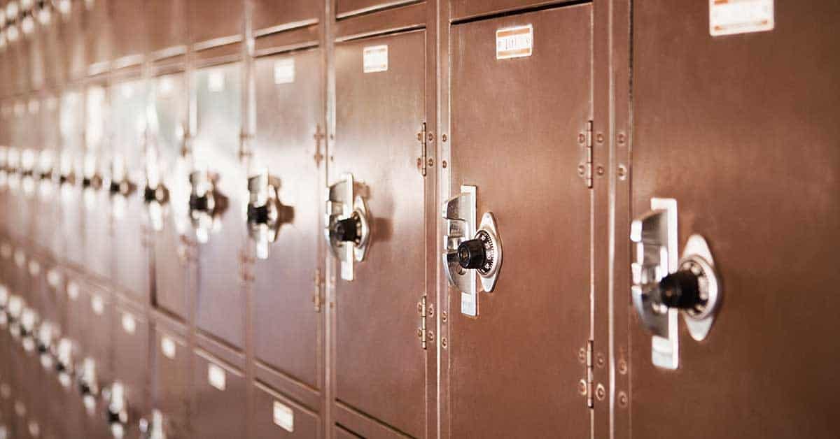 A row of brown metal lockers with combination locks lines the internal hallway.