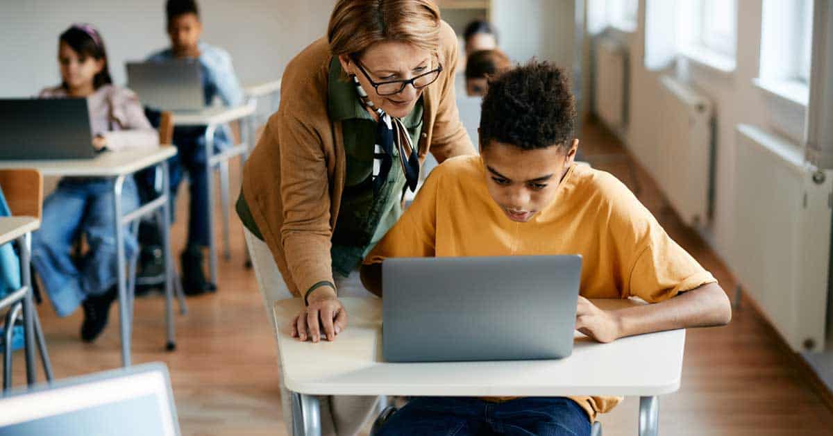 Students using laptops in a classroom illustrating technology integration in education