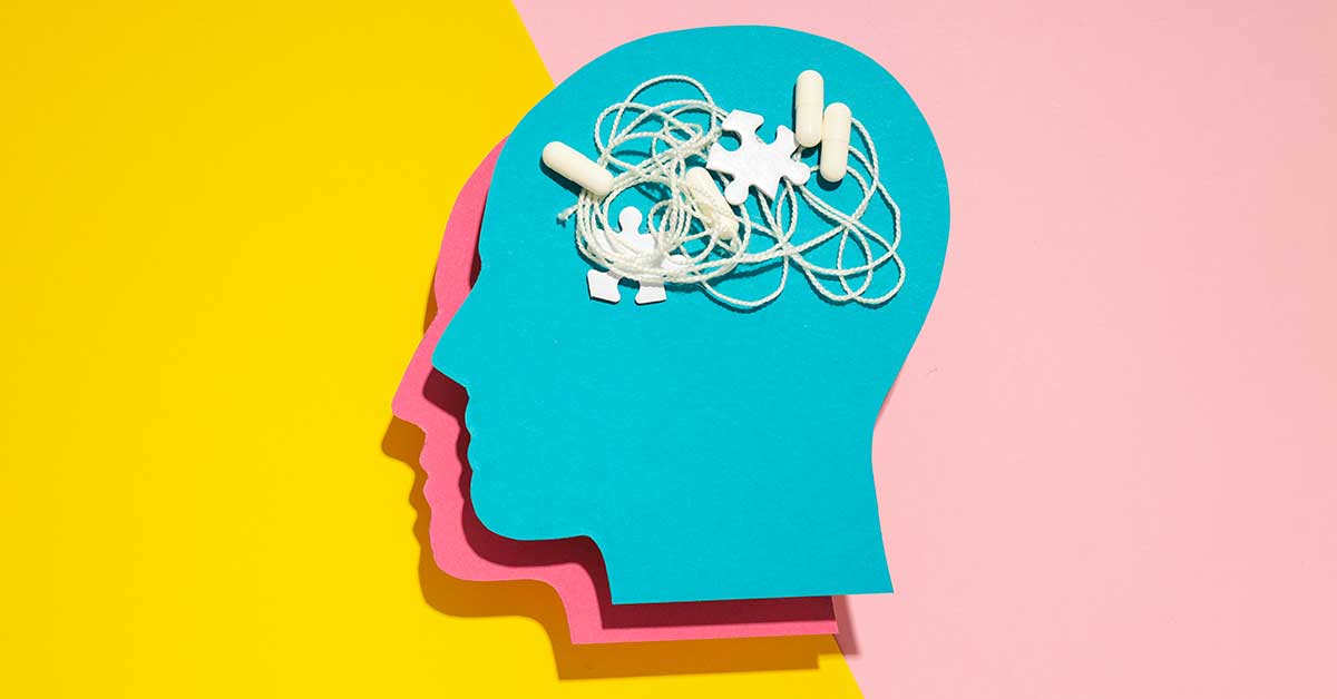 A blue paper cutout of a human head with tangled string and puzzle pieces on top, symbolizing mental confusion, on a vibrant yellow and pink background—perfect for TikTok posts about mental health awareness.